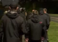 Go home: Dressed in all black, UK vigilantes bar Indian students from park