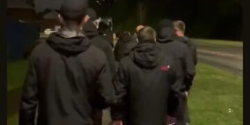 Go home: Dressed in all black, UK vigilantes bar Indian students from park